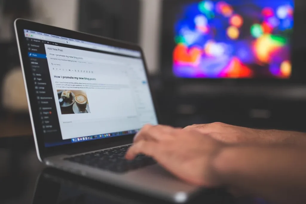 hands typing on a laptop designing a website